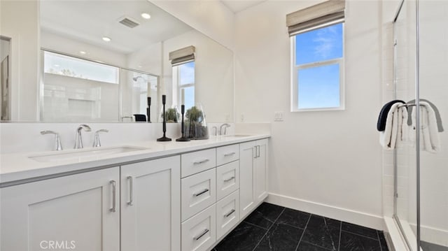 full bath featuring visible vents, a sink, and a wealth of natural light