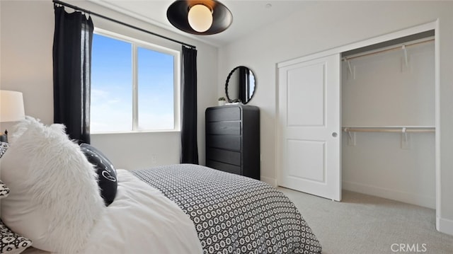 bedroom with baseboards, light colored carpet, and a closet