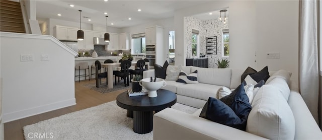 living room featuring baseboards, recessed lighting, and wood finished floors