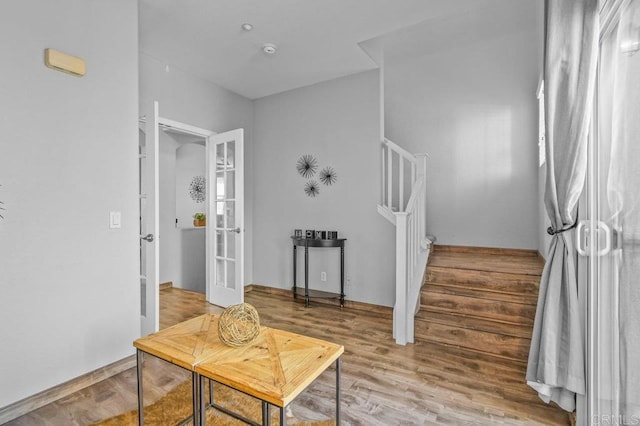 interior space with stairs, french doors, and wood finished floors