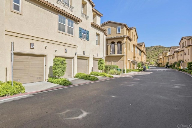 view of street featuring curbs and a residential view