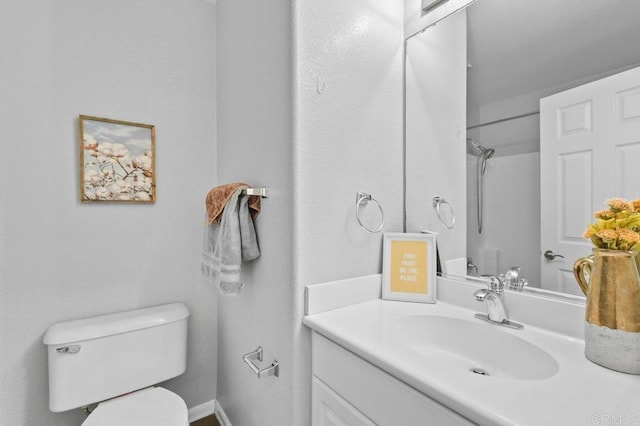 full bath with vanity, toilet, and a shower