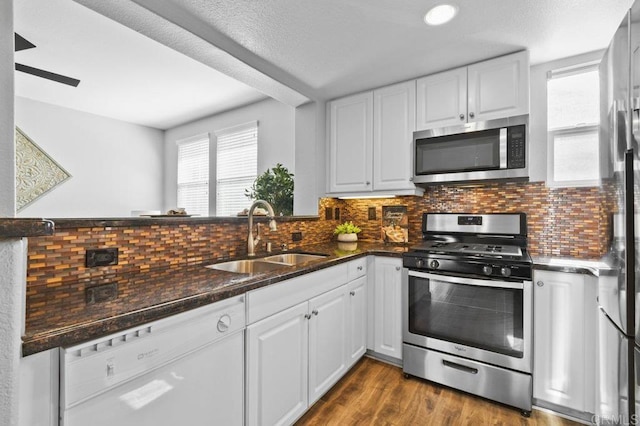 kitchen with a sink, white cabinetry, tasteful backsplash, and stainless steel appliances