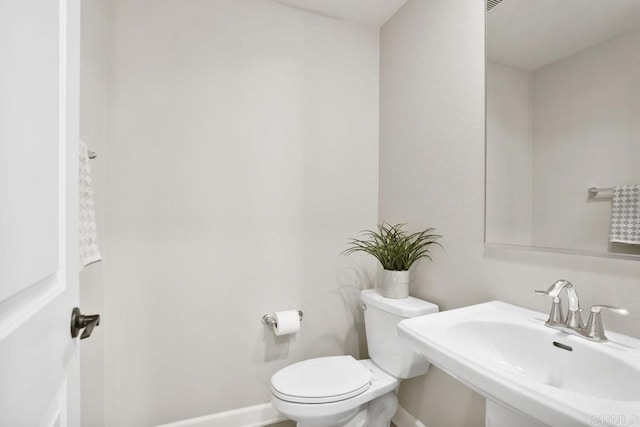 16755 Coyote Bush Dr Unit 32, San Diego, CA 92127 - half bathroom featuring a sink, toilet, and baseboards