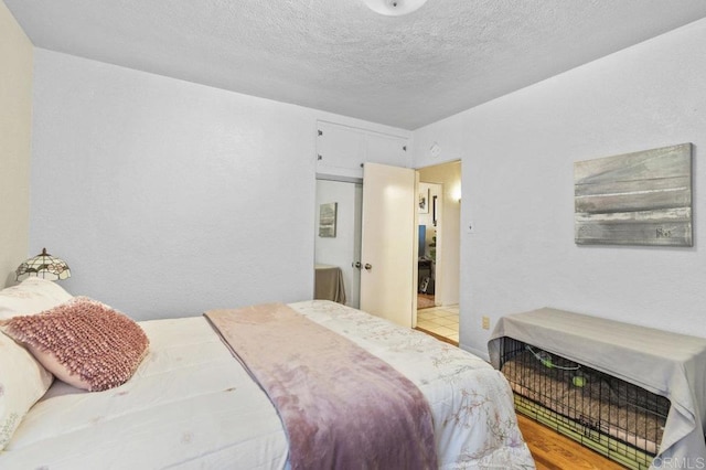 4580 60th St, San Diego, CA 92115 - bedroom with wood finished floors and a textured ceiling