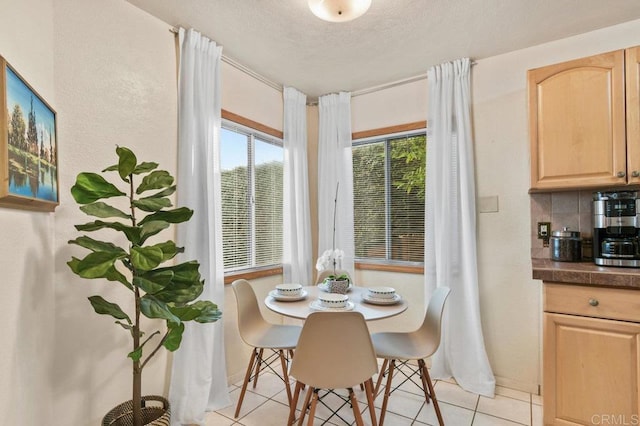 4580 60th St, San Diego, CA 92115 - dining space featuring light tile patterned floors, a textured ceiling, and baseboards