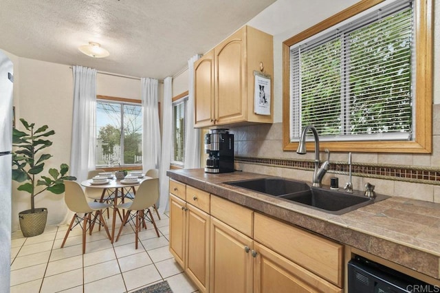 4580 60th St, San Diego, CA 92115 - kitchen with a sink, plenty of natural light, light brown cabinetry, tasteful backsplash, and a textured ceiling