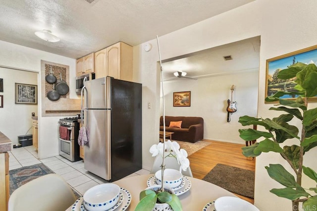 4580 60th St, San Diego, CA 92115 - kitchen with appliances with stainless steel finishes, light brown cabinetry, ceiling fan, a textured ceiling, and open floor plan