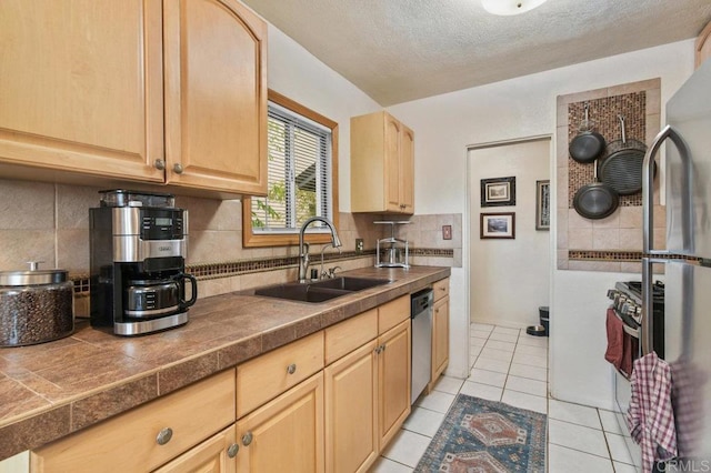 4580 60th St, San Diego, CA 92115 - kitchen with light brown cabinets, stainless steel appliances, backsplash, light tile patterned floors, and a textured ceiling