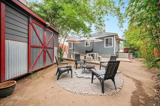 4580 60th St, San Diego, CA 92115 - view of patio / terrace with a fire pit and a storage shed