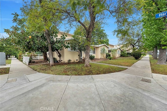 view of front of house with fence and stucco siding