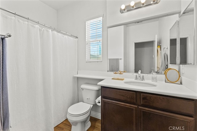 bathroom featuring vanity, wood finished floors, toilet, and a shower with curtain