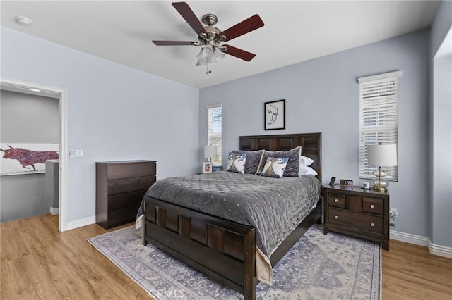 bedroom with baseboards, a ceiling fan, and wood finished floors