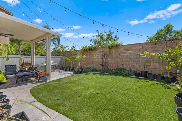 view of yard with a fenced backyard and a patio area