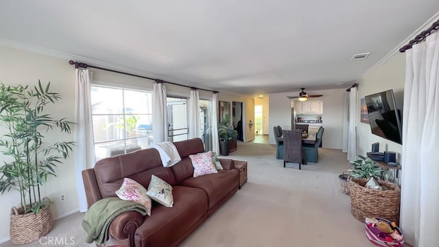 3621 Vista Campana S Unit 56, Oceanside, CA 92057 - living room featuring light colored carpet, ornamental molding, and a ceiling fan