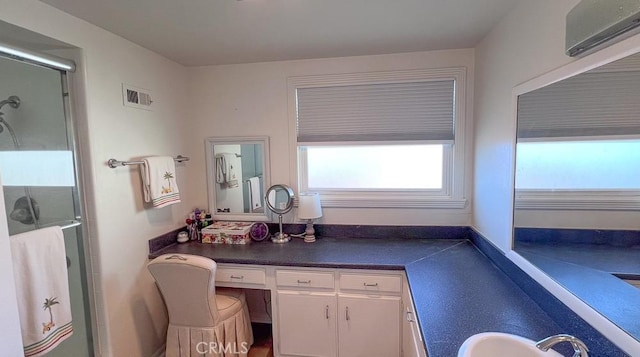 3621 Vista Campana S Unit 56, Oceanside, CA 92057 - full bath featuring a wall unit AC, a stall shower, and vanity