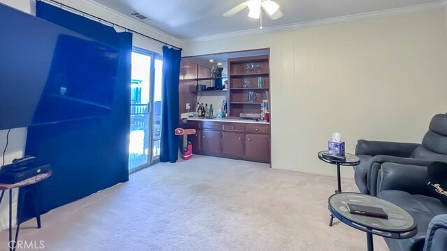 3621 Vista Campana S Unit 56, Oceanside, CA 92057 - living area with bar, ornamental molding, light colored carpet, and ceiling fan