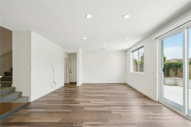 3860 S Oasis Paseo Unit 7, Ontario, CA 91761 - unfurnished living room with stairs, recessed lighting, baseboards, and wood finished floors
