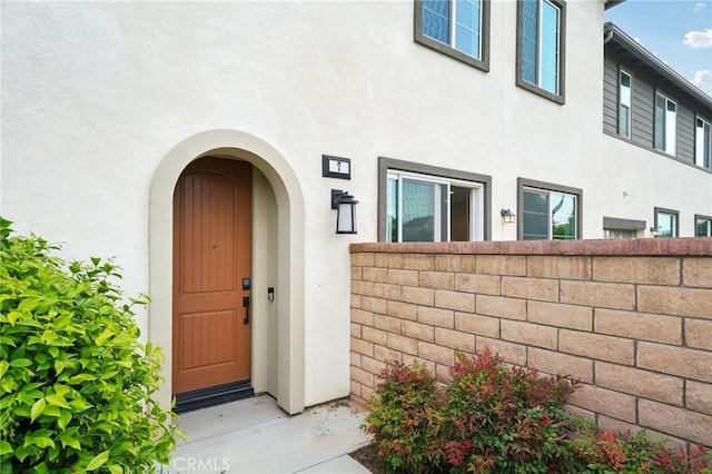3860 S Oasis Paseo Unit 7, Ontario, CA 91761 - doorway to property with stucco siding and fence
