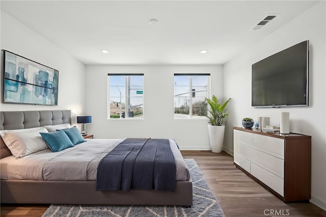 3860 S Oasis Paseo Unit 7, Ontario, CA 91761 - bedroom with baseboards, wood finished floors, and visible vents
