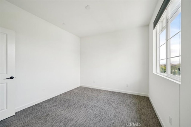 3860 S Oasis Paseo Unit 7, Ontario, CA 91761 - spare room with dark colored carpet and baseboards