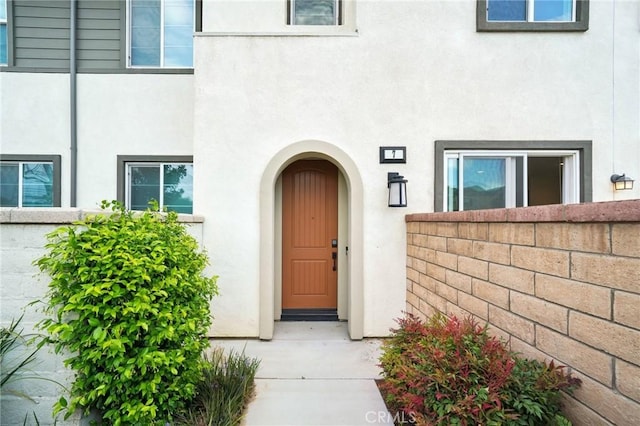 3860 S Oasis Paseo Unit 7, Ontario, CA 91761 - doorway to property featuring fence and stucco siding