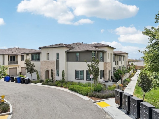 3860 S Oasis Paseo Unit 7, Ontario, CA 91761 - view of front of house with a residential view, stone siding, and stucco siding