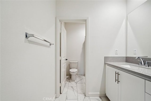 3860 S Oasis Paseo Unit 7, Ontario, CA 91761 - bathroom featuring vanity, marble finish floor, baseboards, and toilet