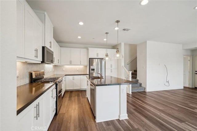 3860 S Oasis Paseo Unit 7, Ontario, CA 91761 - kitchen featuring visible vents, dark countertops, dark wood-style floors, recessed lighting, and stainless steel appliances