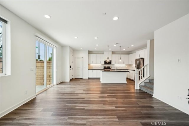3860 S Oasis Paseo Unit 7, Ontario, CA 91761 - unfurnished living room featuring recessed lighting, a sink, dark wood finished floors, and a healthy amount of sunlight