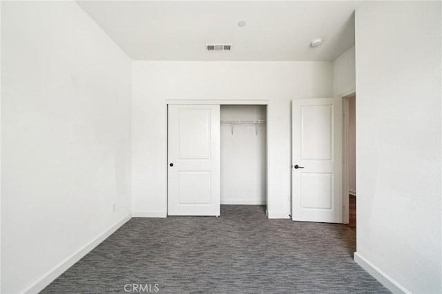 3860 S Oasis Paseo Unit 7, Ontario, CA 91761 - unfurnished bedroom featuring visible vents, baseboards, dark carpet, and a closet
