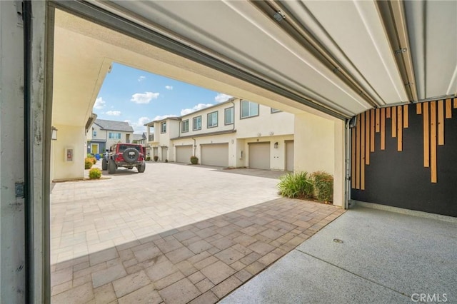 3860 S Oasis Paseo Unit 7, Ontario, CA 91761 - garage with driveway and a residential view