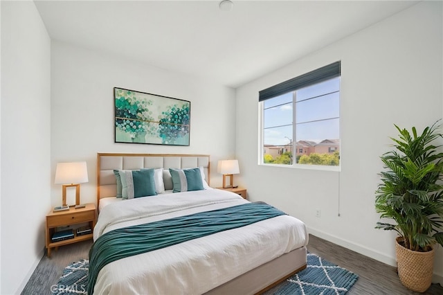 3860 S Oasis Paseo Unit 7, Ontario, CA 91761 - bedroom with baseboards and wood finished floors