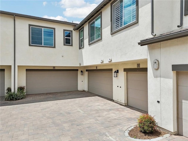 3860 S Oasis Paseo Unit 7, Ontario, CA 91761 - exterior space featuring a garage, stucco siding, and driveway