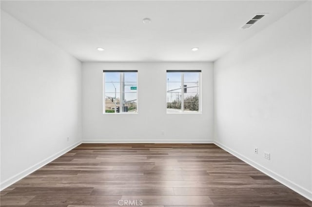 3860 S Oasis Paseo Unit 7, Ontario, CA 91761 - unfurnished room with recessed lighting, baseboards, visible vents, and dark wood-type flooring
