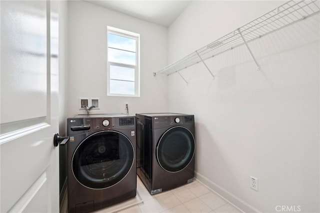 3860 S Oasis Paseo Unit 7, Ontario, CA 91761 - laundry room with light tile patterned floors, baseboards, laundry area, and washing machine and dryer