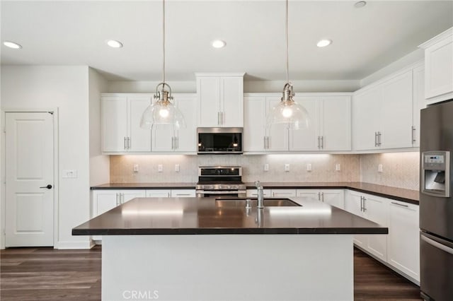 3860 S Oasis Paseo Unit 7, Ontario, CA 91761 - kitchen featuring dark countertops, tasteful backsplash, stainless steel appliances, recessed lighting, and dark wood-type flooring