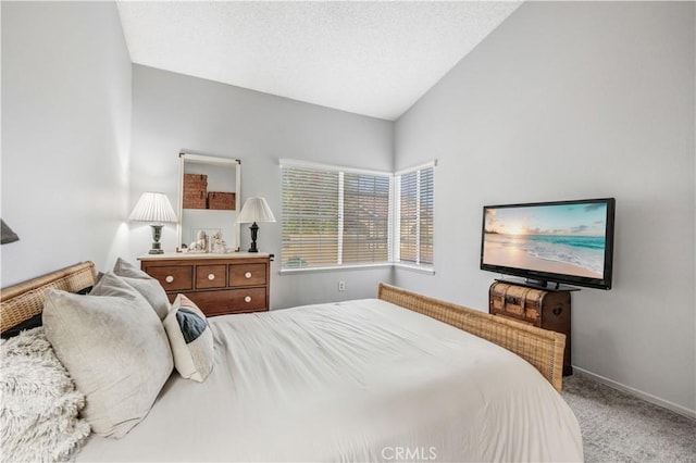 bedroom with carpet floors, baseboards, and vaulted ceiling