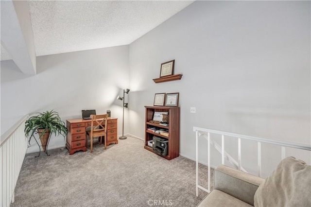 office area with carpet flooring, a textured ceiling, and lofted ceiling