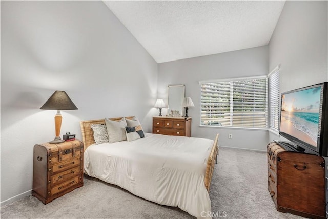 carpeted bedroom featuring baseboards, a textured ceiling, and lofted ceiling