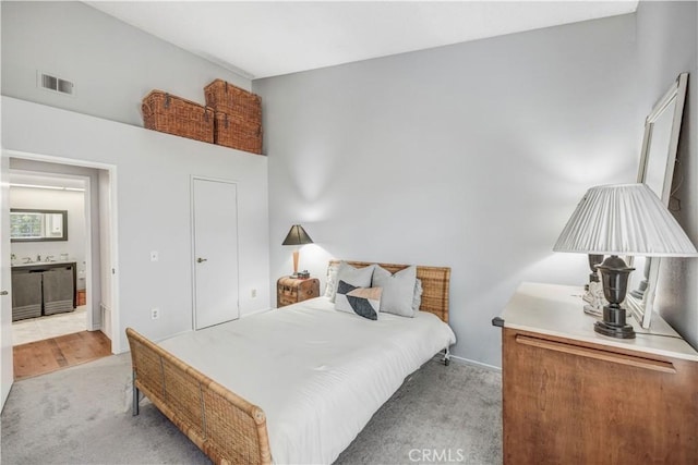 bedroom with baseboards, light carpet, and visible vents