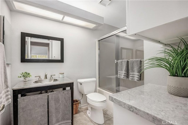 bathroom featuring vanity, tile patterned flooring, and toilet