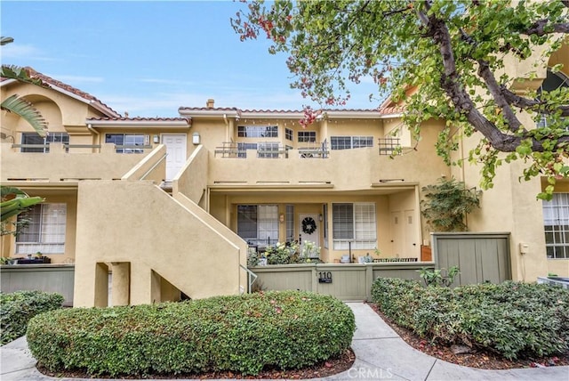 multi unit property featuring stucco siding and a balcony