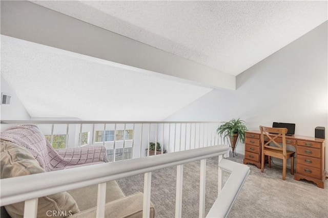 carpeted home office featuring vaulted ceiling with beams, a textured ceiling, and visible vents