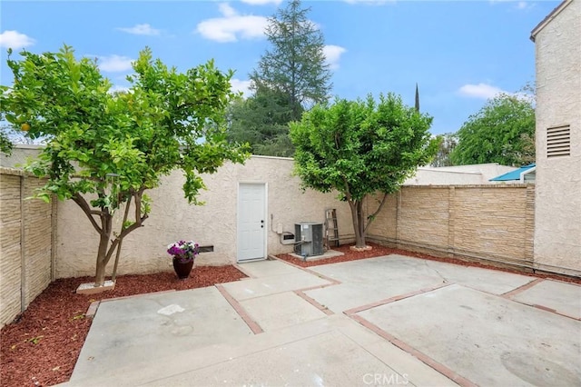 view of patio with a fenced backyard and central AC unit
