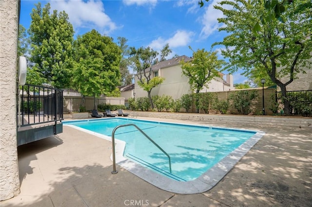 view of pool featuring a fenced in pool, a fenced backyard, and a patio area