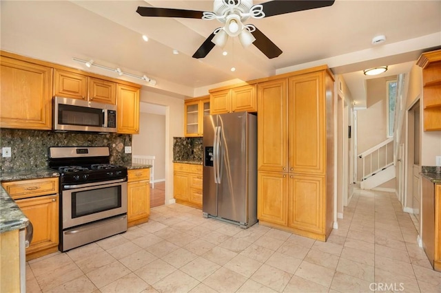 kitchen featuring appliances with stainless steel finishes, ceiling fan, backsplash, and light tile patterned flooring