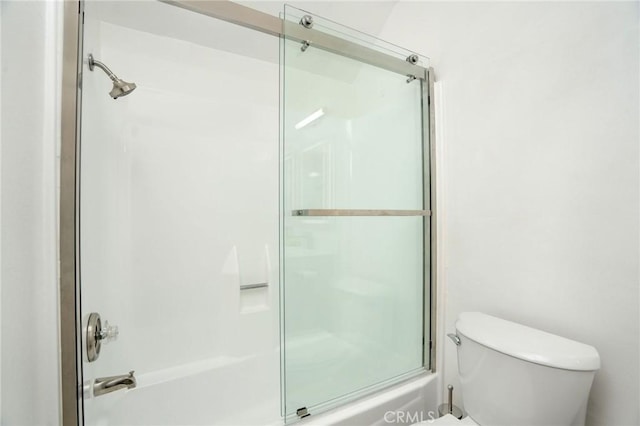 full bath featuring bath / shower combo with glass door and toilet