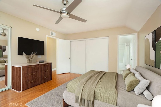 bedroom with visible vents, a closet, ceiling fan, light wood-type flooring, and connected bathroom