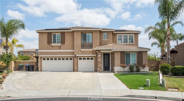 view of front of home with an attached garage, concrete driveway, solar panels, and stucco siding